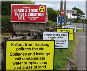 A clutch of anti fracking signs